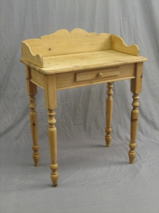 A pine wash stand with three-quarter gallery, fitted a drawer and raised on turned supports 28"