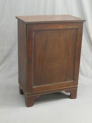 A 19th Century mahogany cabinet, the interior fitted adjustable shelves enclosed by a panelled door and raised on bracket feet 25"