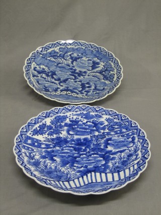 A pair of Japanese  circular blue and white porcelain chargers with scallop shaped borders 18"