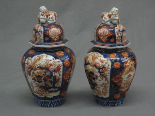 A pair of 19th Century Japanese Imari octagonal shaped urns and covers 12" (f and r) 