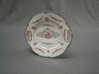 A circular porcelain twin handled cake plate with floral decoration, the reverse marked EG 1794 10"