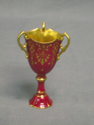 A Coalport circular 3 handled red glazed cup, the base marked P103 V4595 4 1/2"