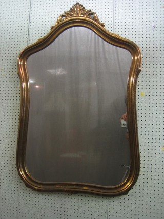A shaped plate wall mirror contained in a gilt frame 43"