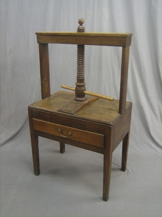 An 18th Century elm book press, the base fitted a drawer, raised on square tapering supports 27" (some old worm) 