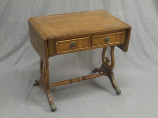 A Georgian style yew miniature sofa table with inset leather top and raised on lyre supports, the base fitted 2 drawers 24"