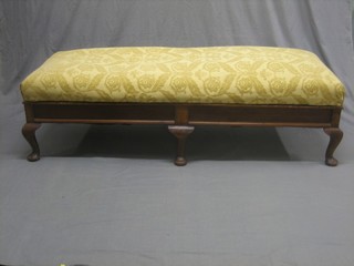 A rectangular walnut ottoman with upholstered hinged seat, raised on 6 cabriole supports 58"