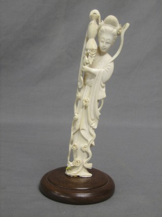 A carved ivory figure of a standing Geisha girl 8"