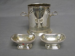 A pair of 19th Century silver plated salts with gadrooned decoration 3"  and a pierced silver plated twin handled soda siphon holder