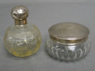 A circular cut glass silver dressing table jar with silver lid, London 1913 and a globular etched glass perfume bottle with silver stopper Birmingham 1911