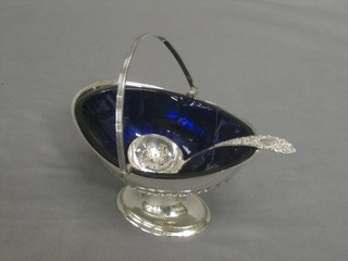 A silver plated boat shaped sugar bowl with blue glass liner and swing handle (f)