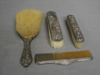 An  embossed silver backed hair brush and 2 silver backed clothes brushes and comb