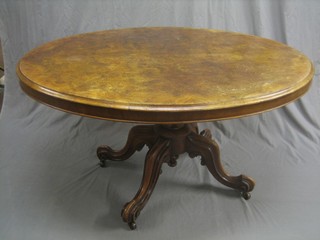 A Victorian oval figured walnut Loo table, raised on a turned column tripod base 54"