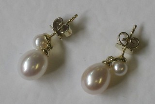 A pair of pearl drop earrings