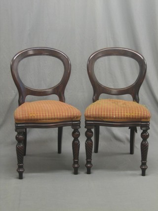A set of 10 Victorian style mahogany balloon back dining chairs with upholstered seats, raised on spiral turned supports