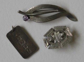 A silver ingot pendant and 2 silver brooches