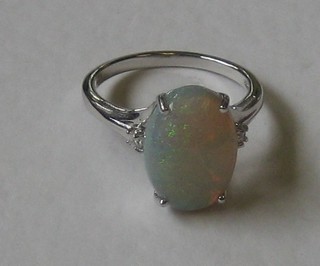 A lady's 18ct white gold dress ring set an oval cut opal supported by diamonds