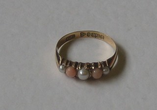 A lady's 9ct gold dress ring set demi-pearls and coral