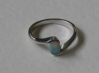 A lady's silver dress ring set an oval cut opal
