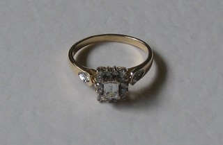 A lady's 18ct yellow gold dress ring set an emerald cut diamond surrounded by diamonds, approx 0.37ct