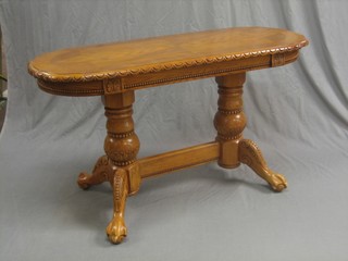 A German style rectangular carved oak occasional table, raised on pillar and tripod supports