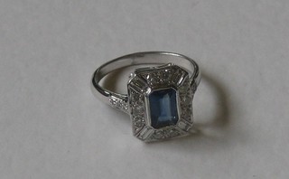 A lady's 18ct white gold dress ring set a rectangular cut sapphire surrounded by diamonds  approx 0.55/1ct