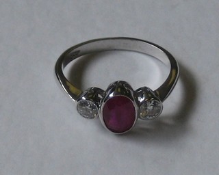 A lady's 18ct white gold dress ring set an oval cut ruby supported by 2 diamonds, approx 0.35/0.65ct