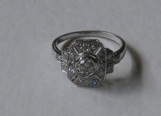 A lady's Art Deco style 18ct white gold dress ring set a diamond surrounded by numerous diamonds