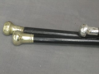 An ebony evening cane with silver mount and 2 others with plated mounts