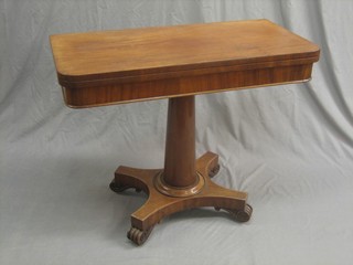 A Victorian mahogany D shaped card table, raised on a turned column with tripod base and raised on scrolled feet 36"