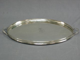 A handsome 19th Century oval galleried silver plated tea tray with armorial decoration 20"