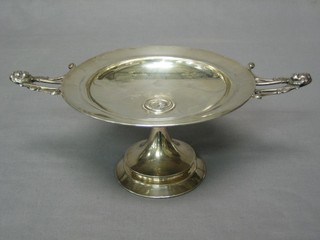 A white metal twin handled dish, raised on a spreading foot, the base marked GEO.G Shrewe & Co