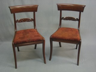 A 19th Century harlequin set of 6 mahogany bar back dining chairs with carved mid rails, raised on front and rear sabre supports 