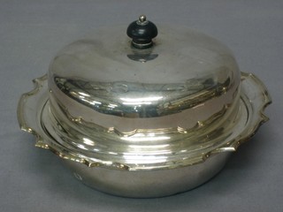 A circular silver plated muffin dish and cover