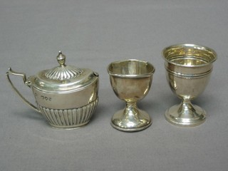 A Victorian oval fluted silver mustard pot London 1895 and 2 silver egg cups