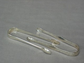 A pair of Georgian silver bright cut sugar tongs and 1 other pair 2 ozs