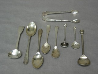 A pair of silver sugar tongs, 2 silver salt spoons, do. mustard spoon and 5 other spoons, 2 ozs