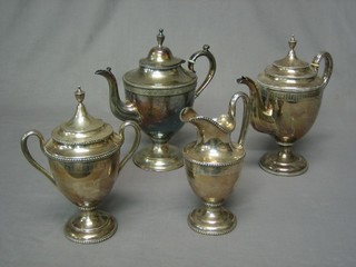 An American style 4 piece silver plated tea/coffee service with tea pot, coffee pot, twin handled sugar bowl and milk jug with bead and Grecian key decoration