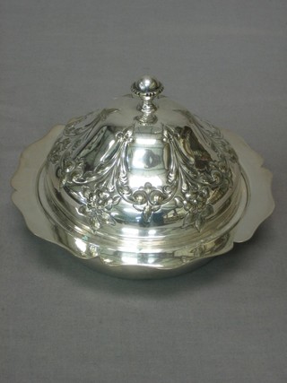 A circular embossed silver plated muffin dish and cover