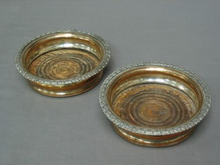 A pair of circular silver plated wine coasters