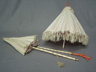A Victorian parasol with ivory and coral handle (f) and 1 other (f)