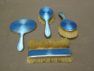 A 5 piece silver and blue enamelled backed dressing table set comprising pair of clothes brushes, pair of hair brushes and a hand mirror, Birmingham 1929