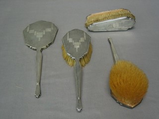 An Art Deco 5 piece silver backed dressing table set, Birmingham 1931 comprising pair of hair brushes, pair of clothes brushes and a hand mirror