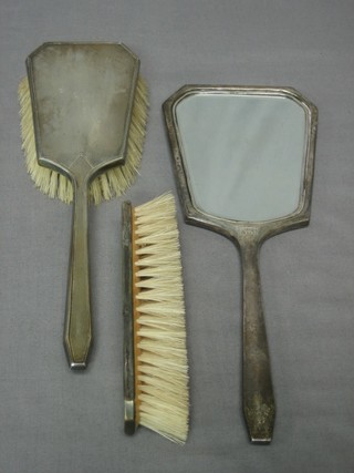 An Art Deco 3 piece silver backed dressing table set with hand mirror, hair brush and clothes brush, Birmingham 1947