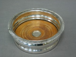 A circular silver plated wine coaster