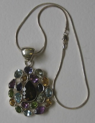 A large silver pendant set numerous semi-precious stones