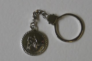 A silver St Christopher key ring medallion