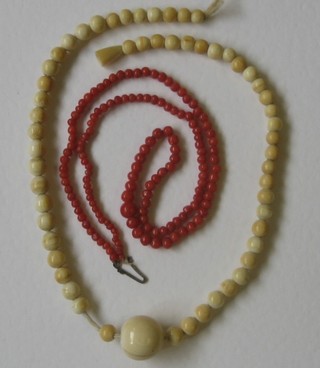 A string of ivory beads and a string of coral beads