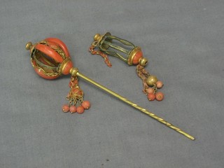 A gilt metal and coral hat pin