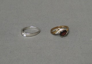 A lady's 9ct yellow gold dress ring set red and white stones and a silver dress ring set a white stone