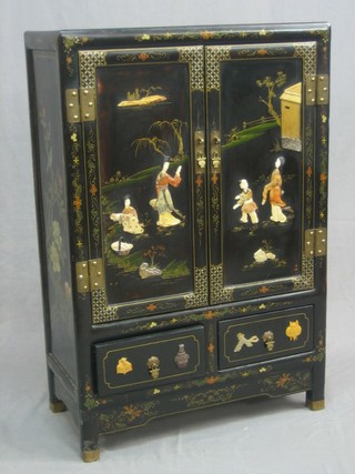 An Oriental lacquered cabinet with inlaid hardstone decoration, enclosed by panelled doors 24"